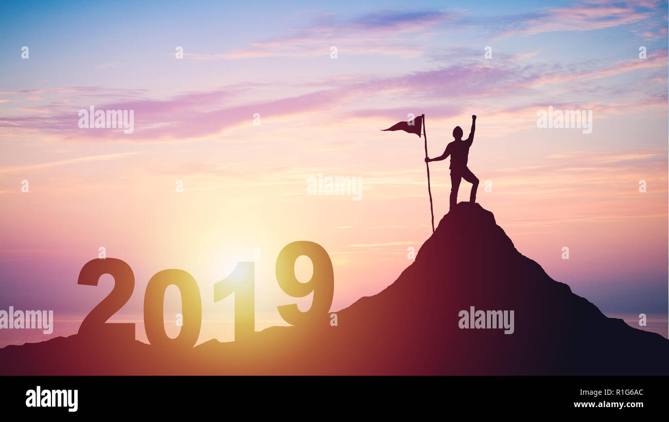 silhouette of man with flag on mountain top over sunset Stock Photo - Alamy