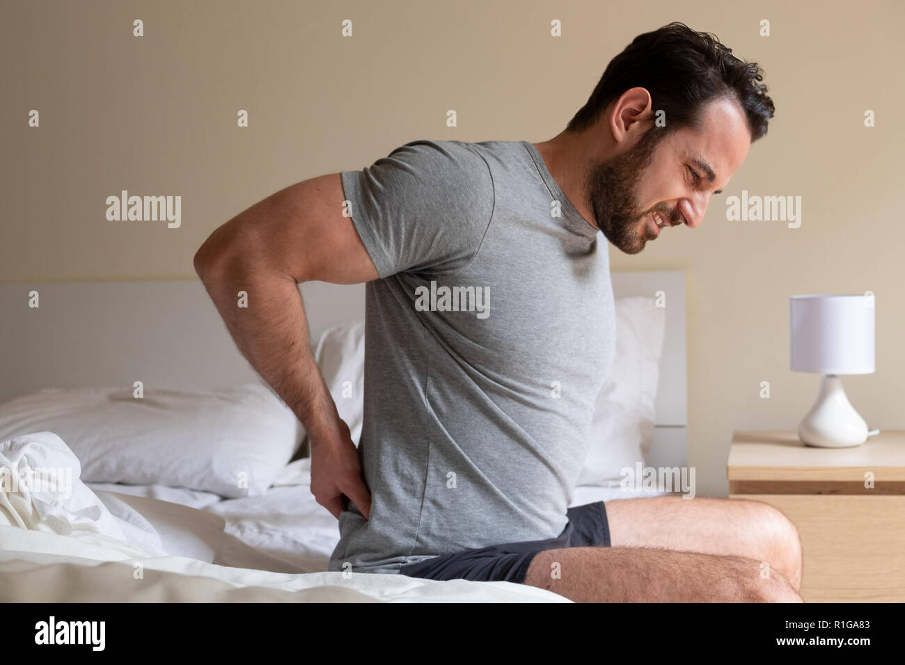 Man feeling backache after sleeping in bed Stock Photo Alamy