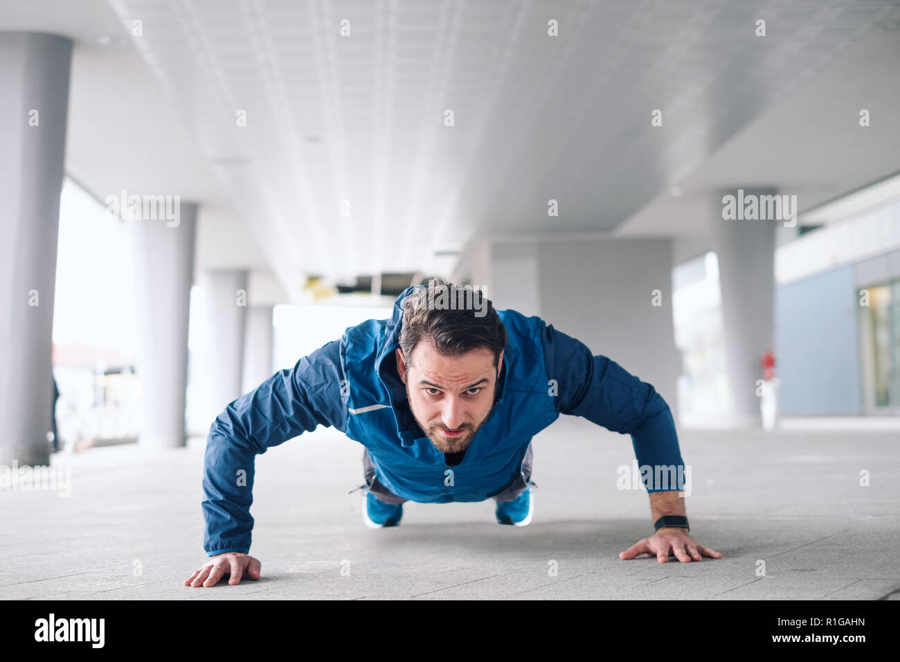 Urban sportsman doing push-ups reps exercise Stock Photo