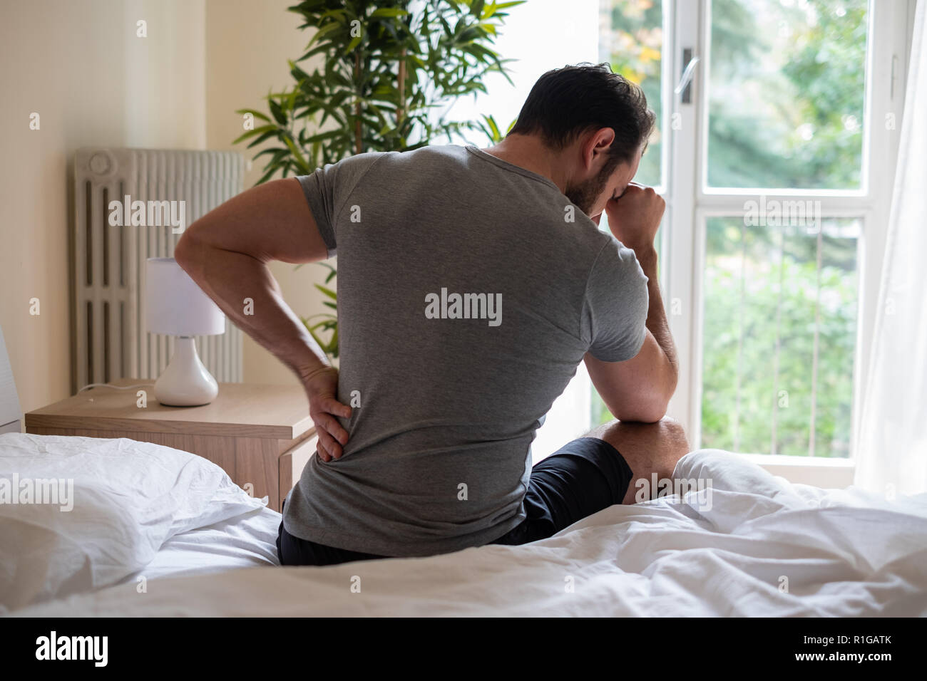 Man feeling backache after sleeping in bed Stock Photo Alamy