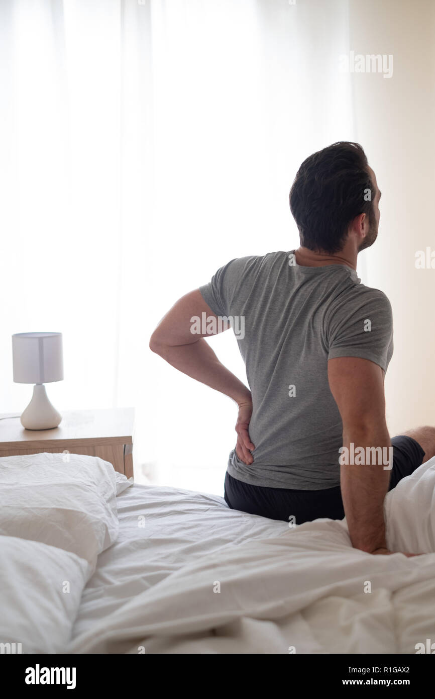 Man feeling backache after sleeping in bed Stock Photo Alamy