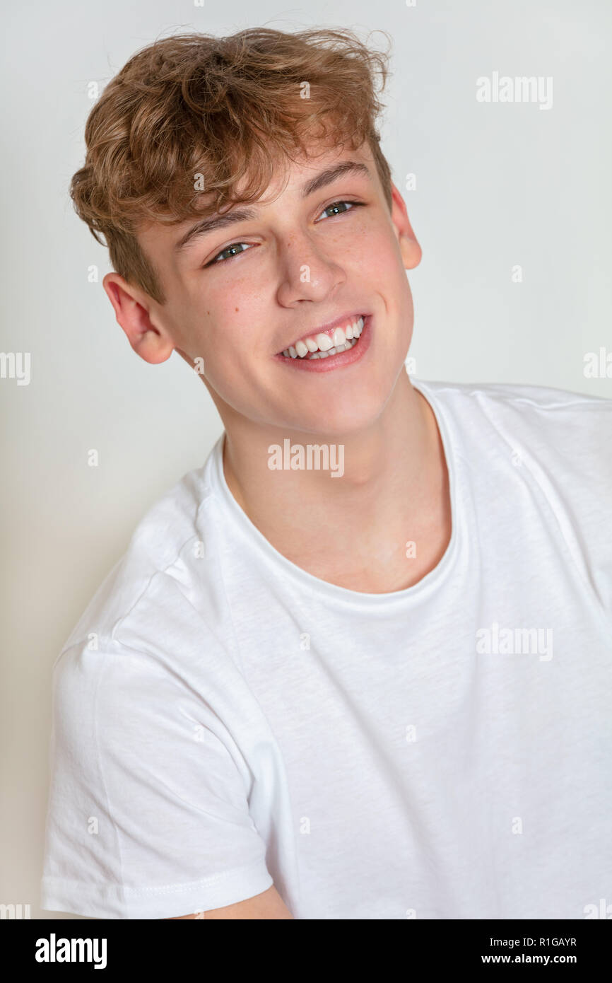 White background studio photograph of young happy boy male teen teenager young adult smiling Stock Photo