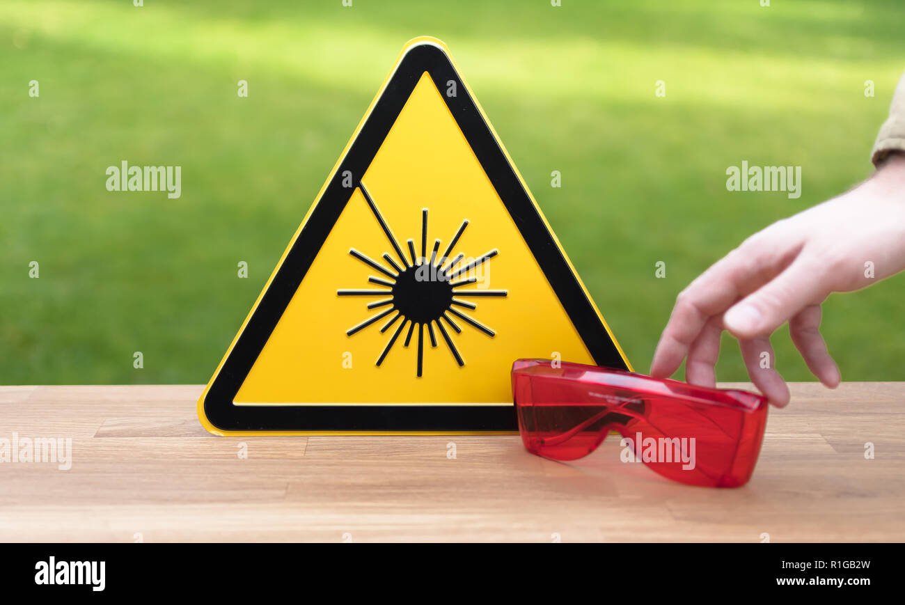 Laser safety sign and safety glasses Stock Photo