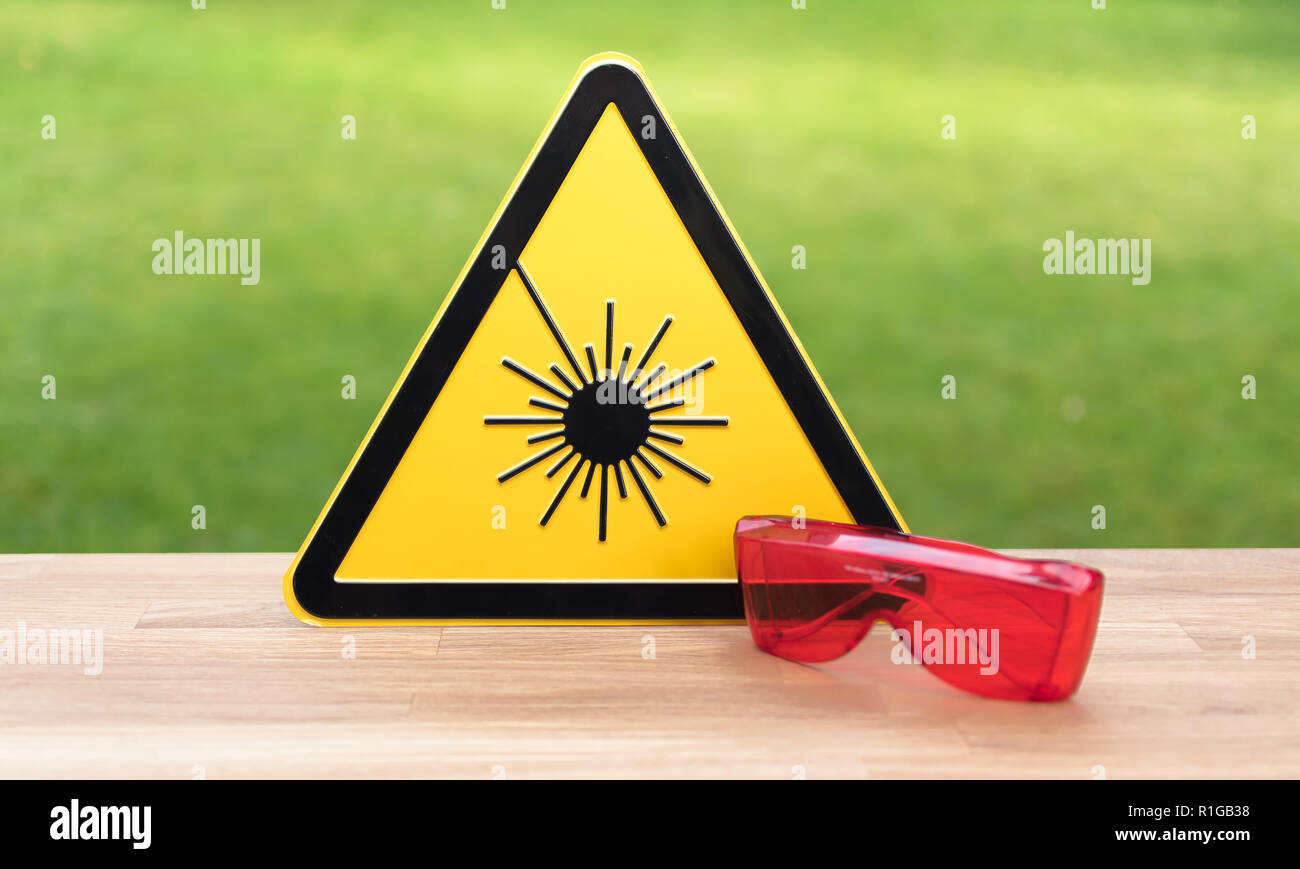 Laser safety sign and safety glasses Stock Photo