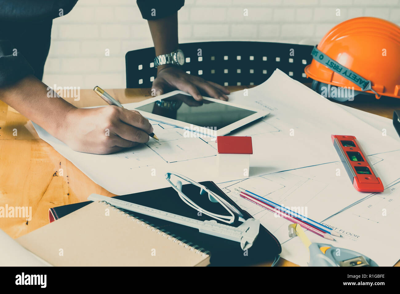 Architect or engineer using pen working on blueprint, architectural concept Stock Photo