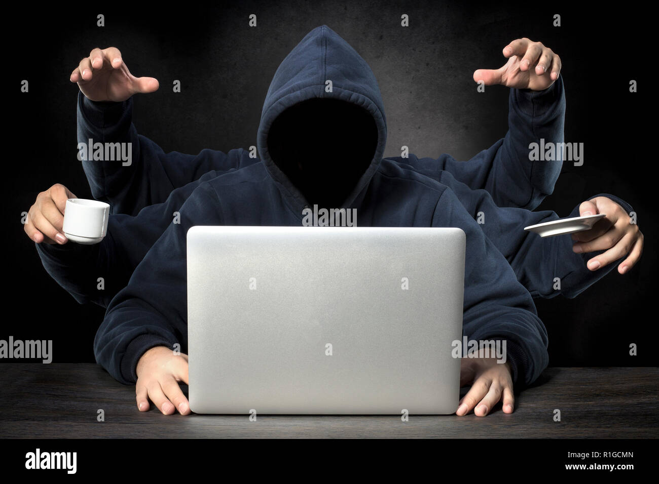 unrecognizable faceless programmer with six hands all a successful workaholic in the workplace Stock Photo