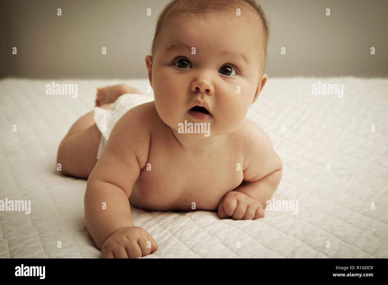 Cute baby lying on belly Stock Photo