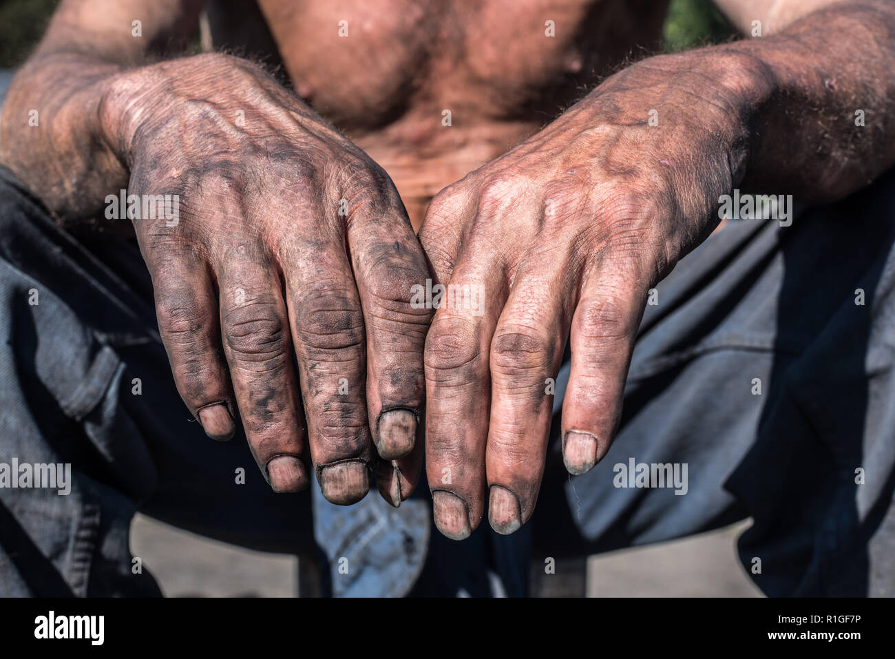 Worker Hands. Charcoal-burners worker man with dirty hands. Stock Photo