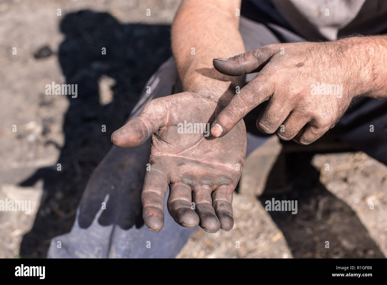 Worker Man with Dirty Hands. Charcoal-burners worker man with dirty hands. Stock Photo