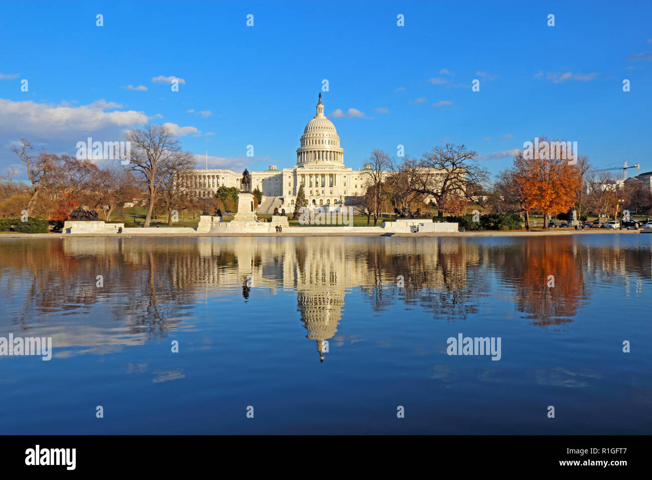 The west side of the United States Capitol building and Ulysses S Grant memorial in Washington, DC reflected in the reflecting pool with Christmas tre Stock Photo