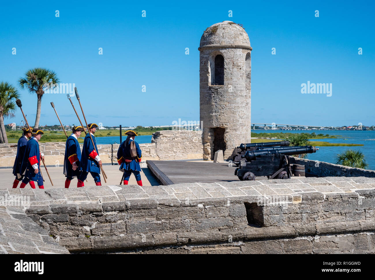 Men in eighteenth century Spanish military costume at Castillo de San Marcos in St Augustine Florida USA firing a cannon on the battlements Stock Photo