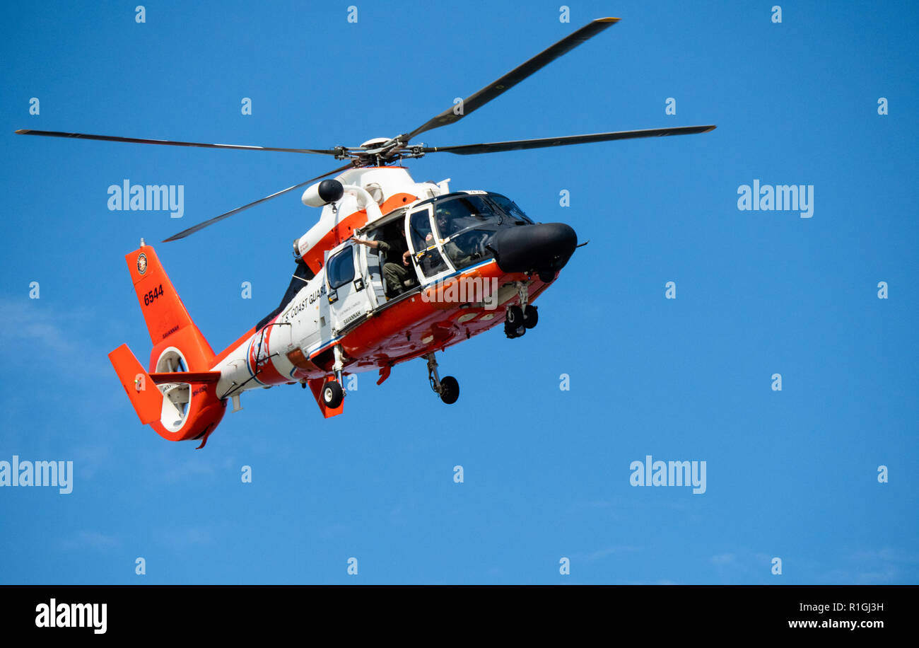 US Coast Guard helicopter flying over the Georgia coast at Tybee Island Savannah Stock Photo
