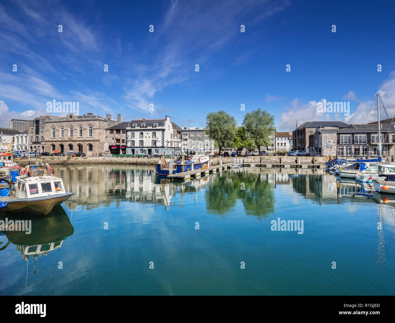 2 June 2018: Plymouth, Devon, UK - The Barbican with The Three Crowns public house reflecting in the water. Stock Photo