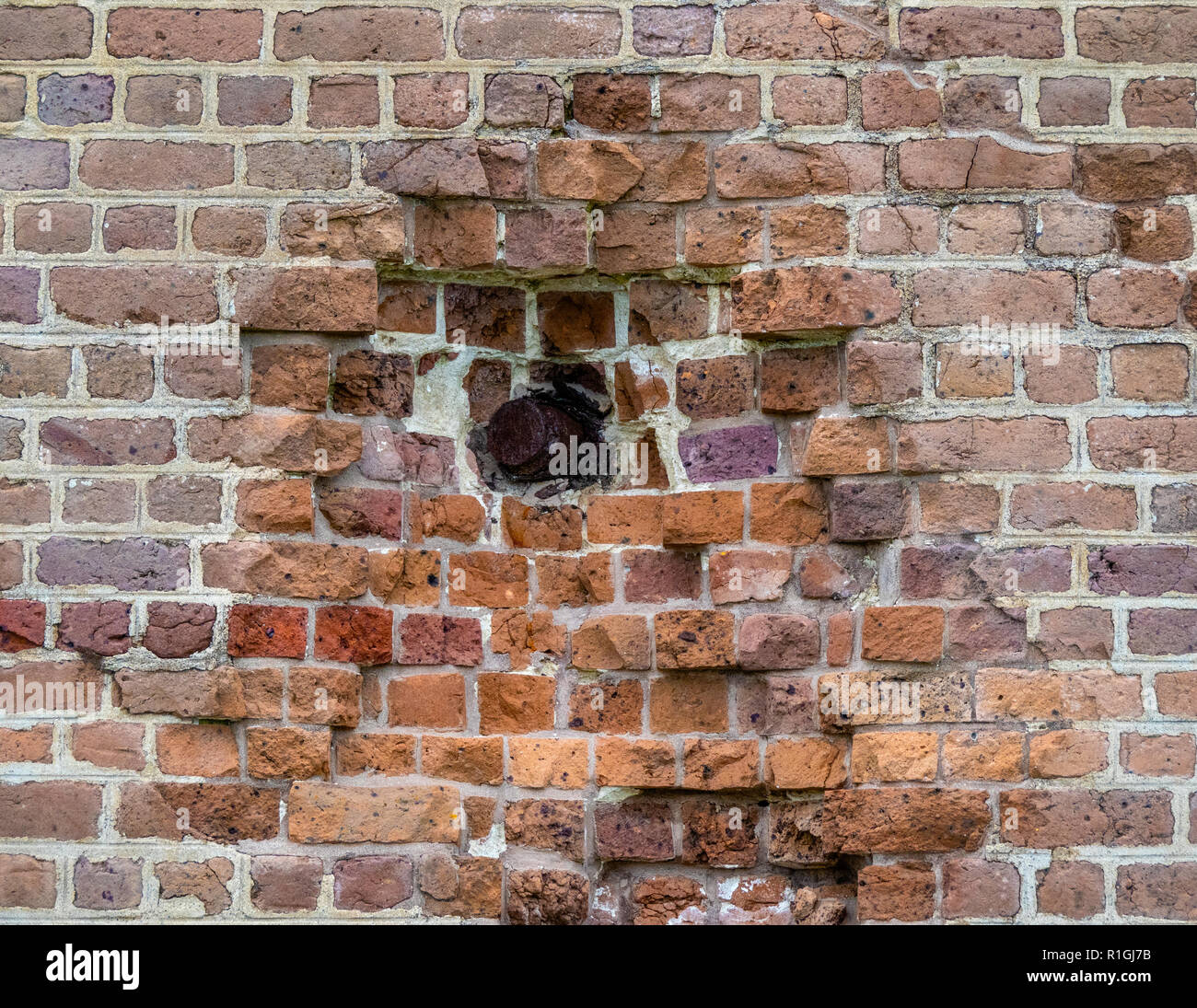 Rifled cannon shell from 1862 drilled through brickwork of Fort Pulaski National Monument guarding the Savannah River in Georgia USA Stock Photo