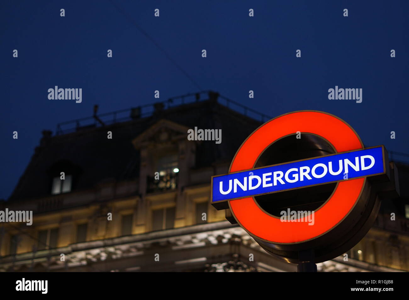 London Underground light sign at night. Stock Photo