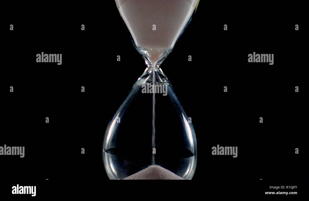 Photo of a isolated hourglass an ancient clock, an instrument for