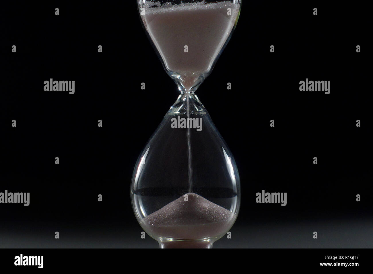 Photo of a isolated hourglass an ancient clock, an instrument for