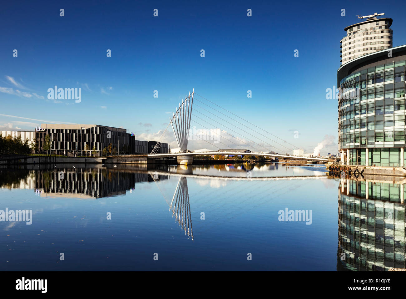 2 November 2018: Salford Quays, Manchester, UK - Media City Footbridge, reflected in the Manchester Ship Canal. Stock Photo