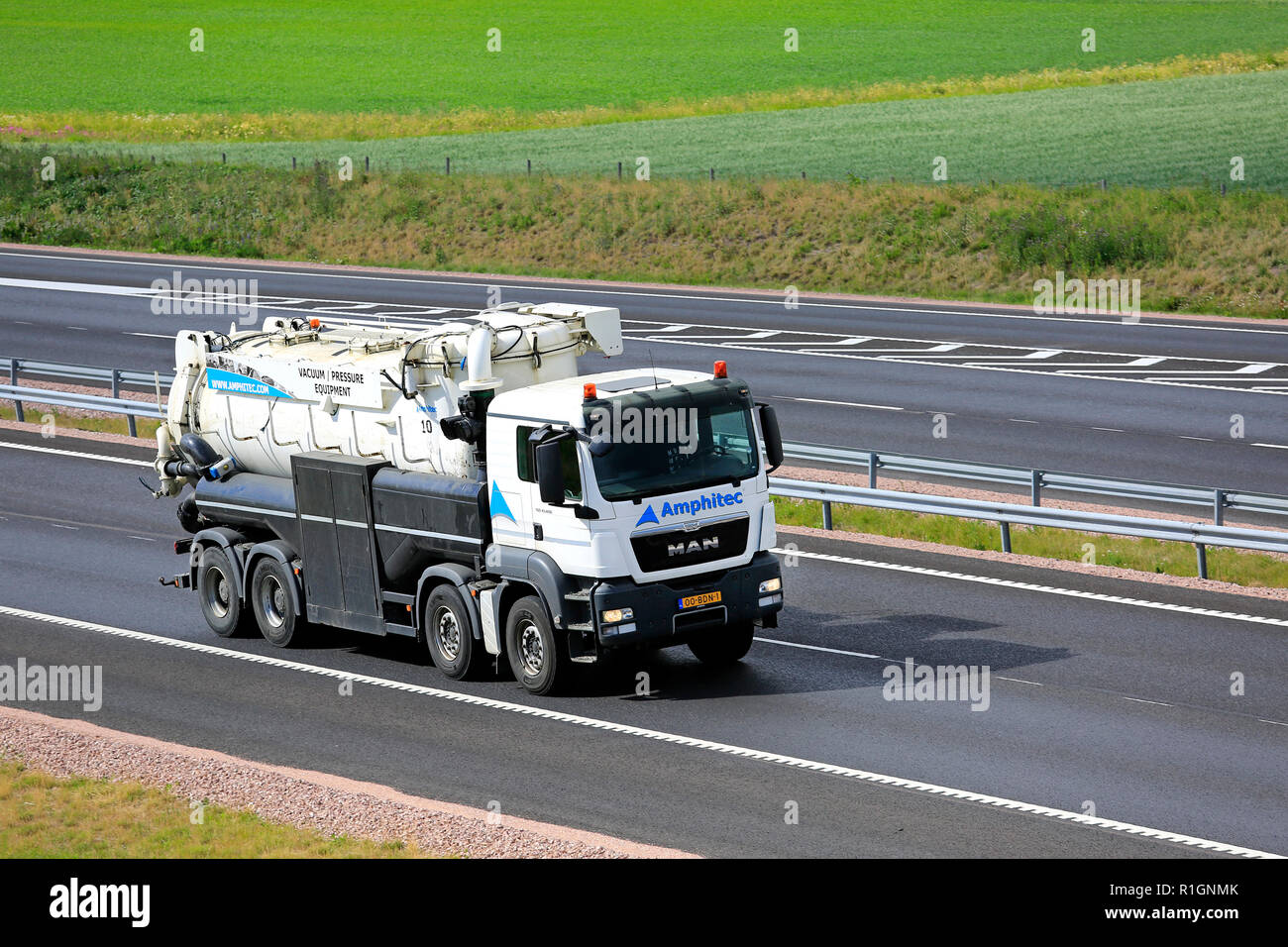 Salo, Finland - June 30, 2018: Amphitec MAN TGS 41.400 vacuum and pressure truck at speed on freeway in the summer in South of Finland. Stock Photo