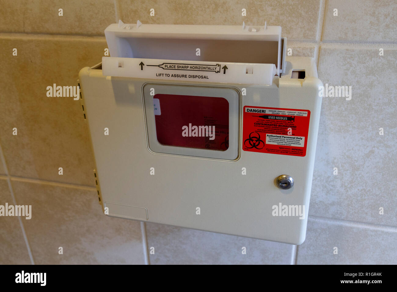 A used hypodermic needle/sharps disposal box in SeaWorld San Diego, California, United States. Stock Photo