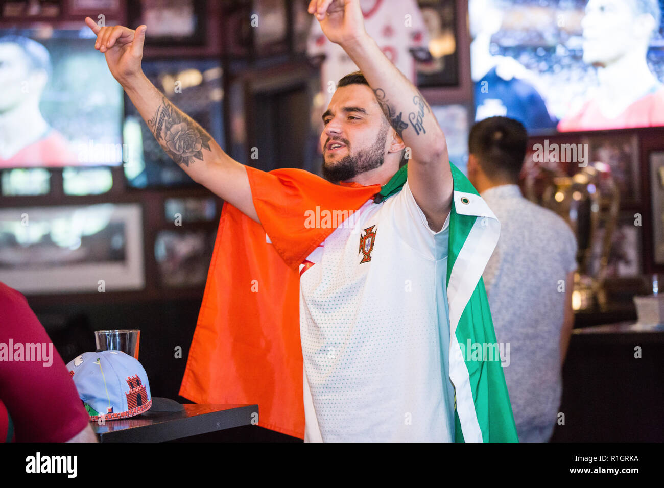 TORONTO, CANADA MAY 5, 2018 SOCCER FAN AT BAR WEARING PORTUGAL FLAG