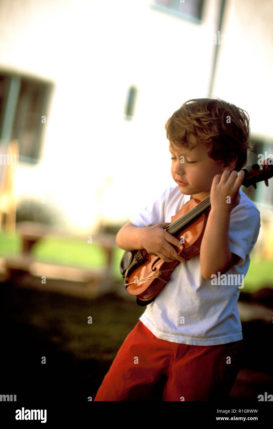 Little boy playing with a violin Stock Photo