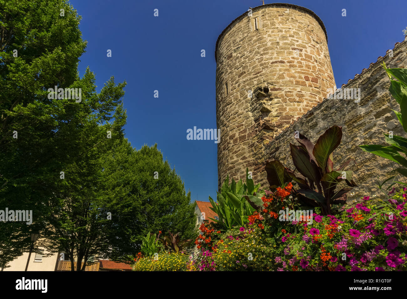 an old watchtower with flowers below Stock Photo - Alamy
