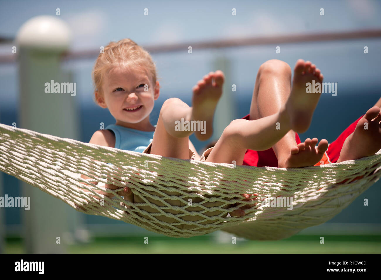Brother and sister swinging in hammock Stock Photo Alamy