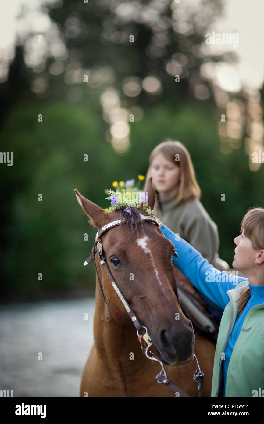 Horse with a teenage girl riding on it. Stock Photo