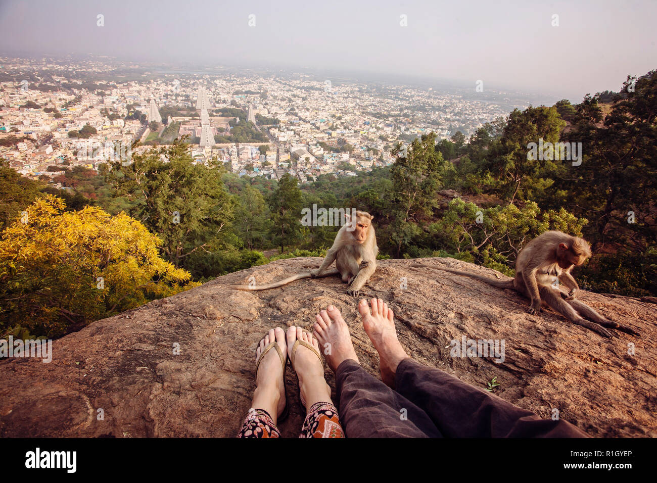 Couple legs sitting at Arunachala mountain view, Tiruvannamalai, Tamil Nadu, India Stock Photo