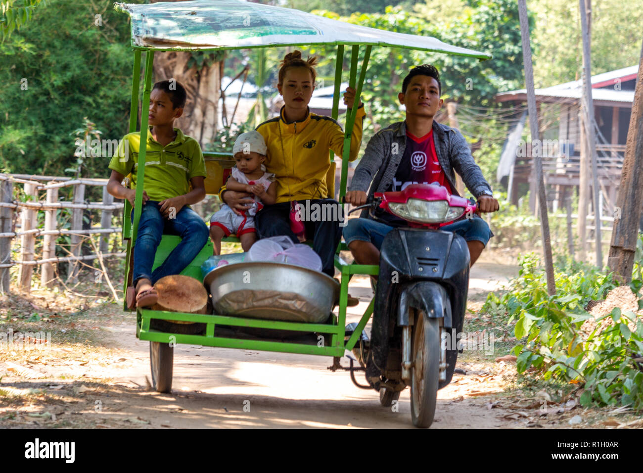 Don Det, Laos - April 22, 2018: Local family getting transported on a sidecar in a small village of southern Laos Stock Photo