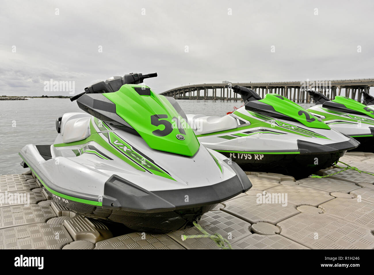 Kawasaki jet skis lined up at the rental dock at the HarborWalk Marina