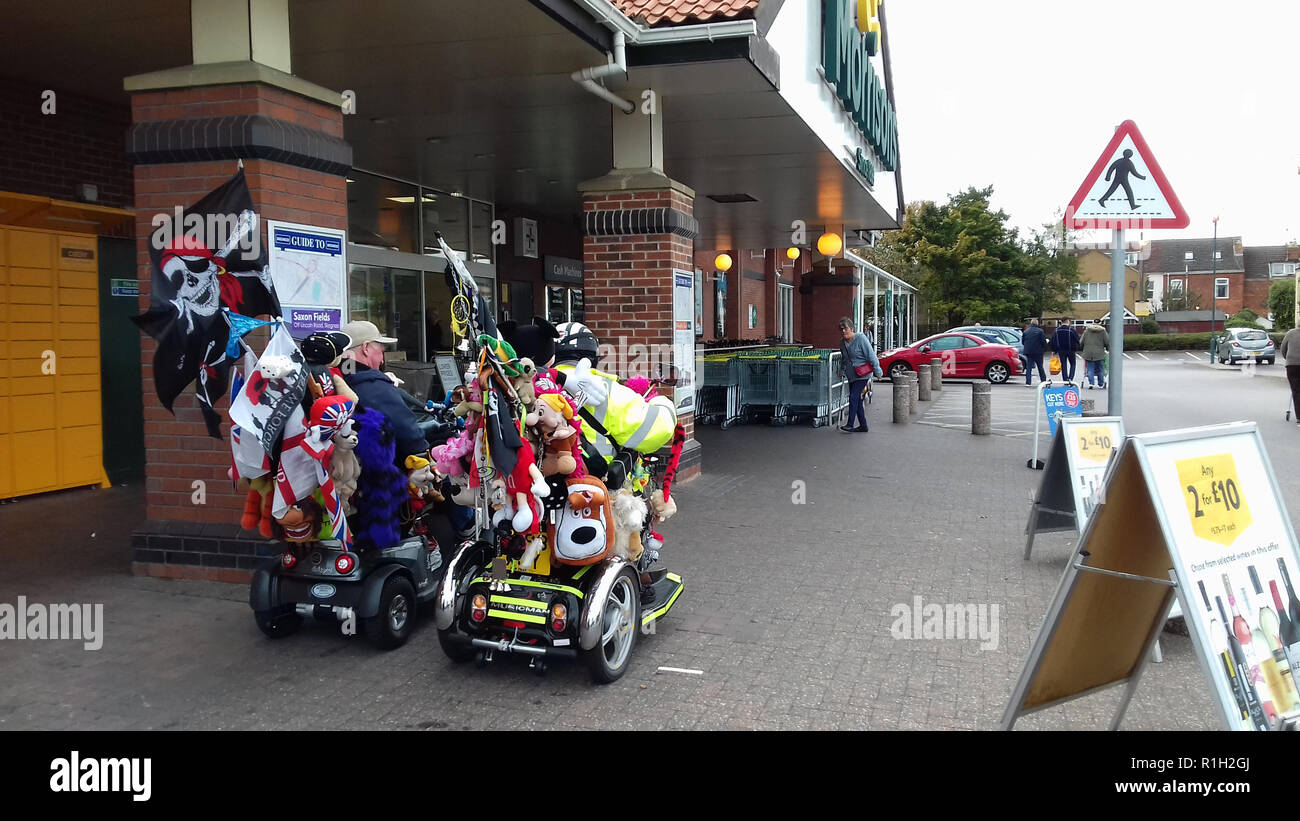 Two Motability Scooter drivers outside Morrisons Supermarket in