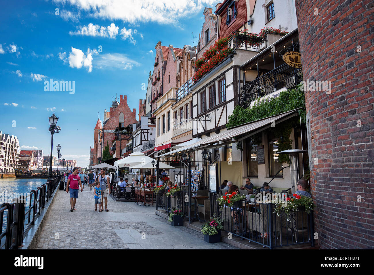 Shore of old harbor, over Motlawa river with historic shore Quayside (Dlugie Pobrzeze) ,the medieval wooden port crane of Gdansk. Stock Photo