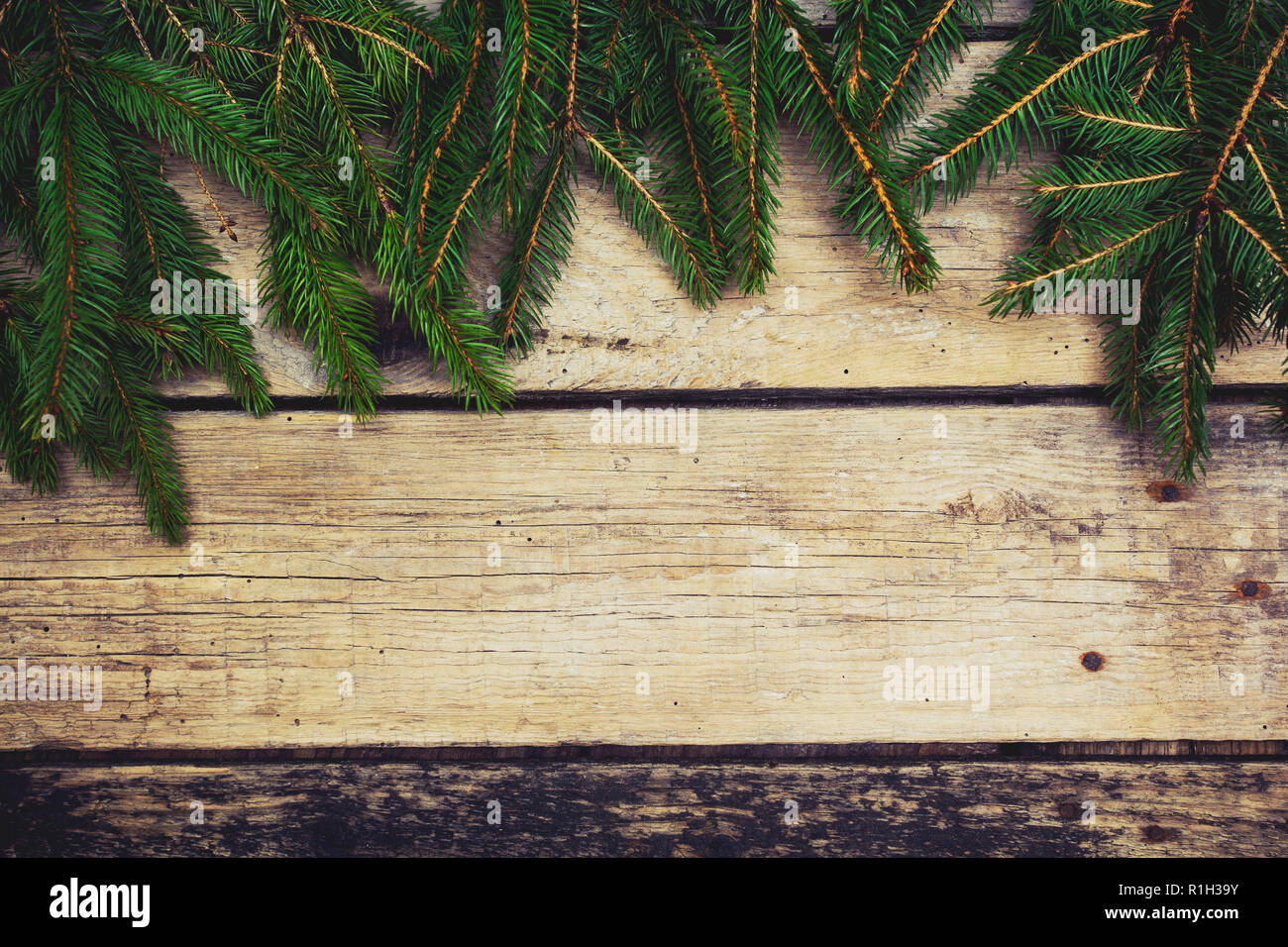 Christmas tree branches on wooden table. Copy space. Stock Photo