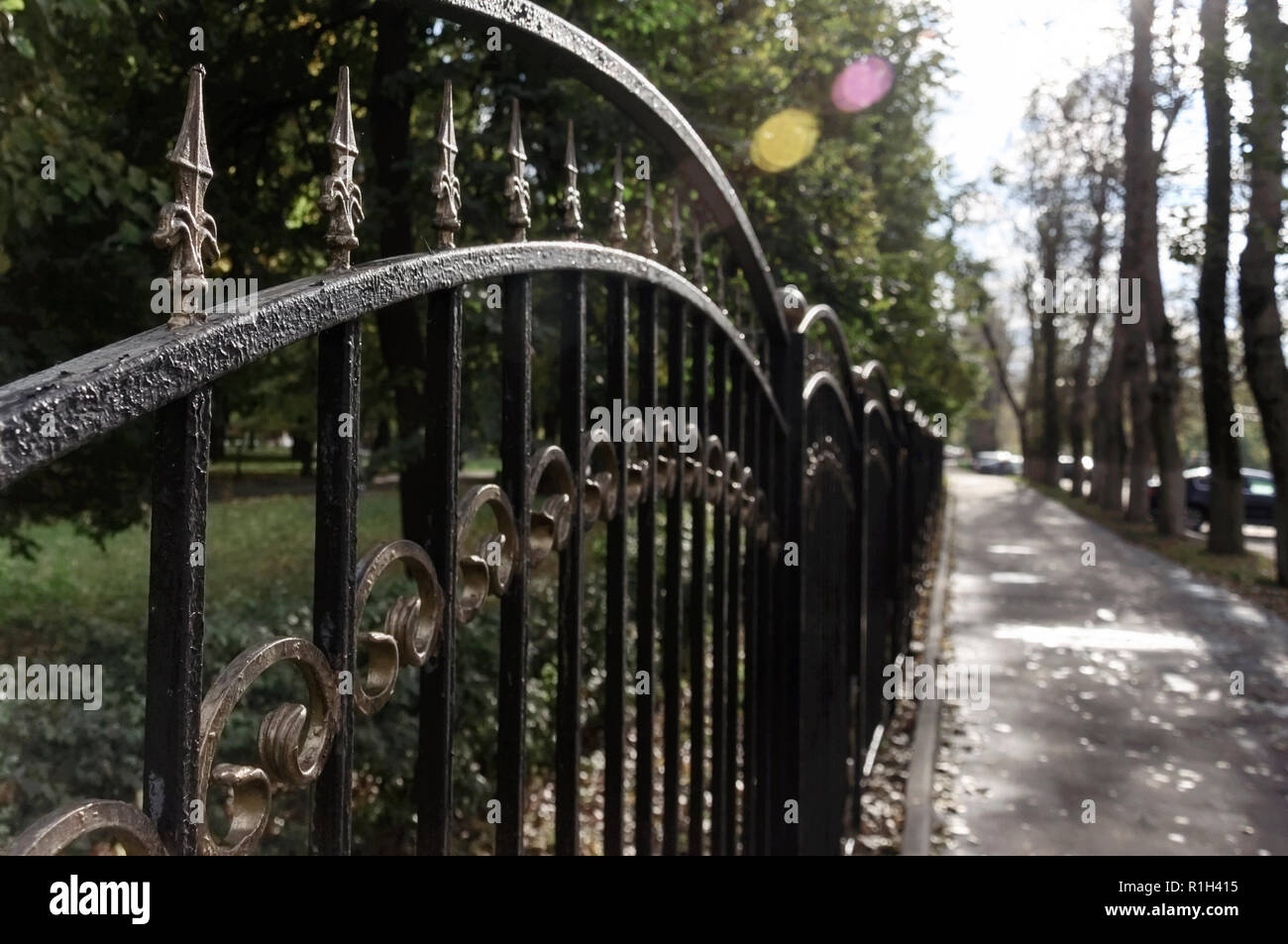 Fence of the city Park in autumn Stock Photo - Alamy