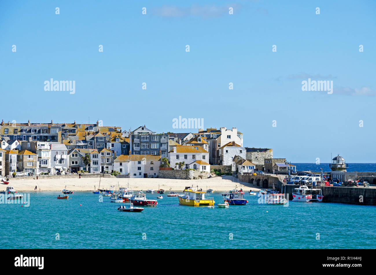 fishing boats and holiday homes apartments, st.ives harbour cornwall, england, britain, uk. Stock Photo