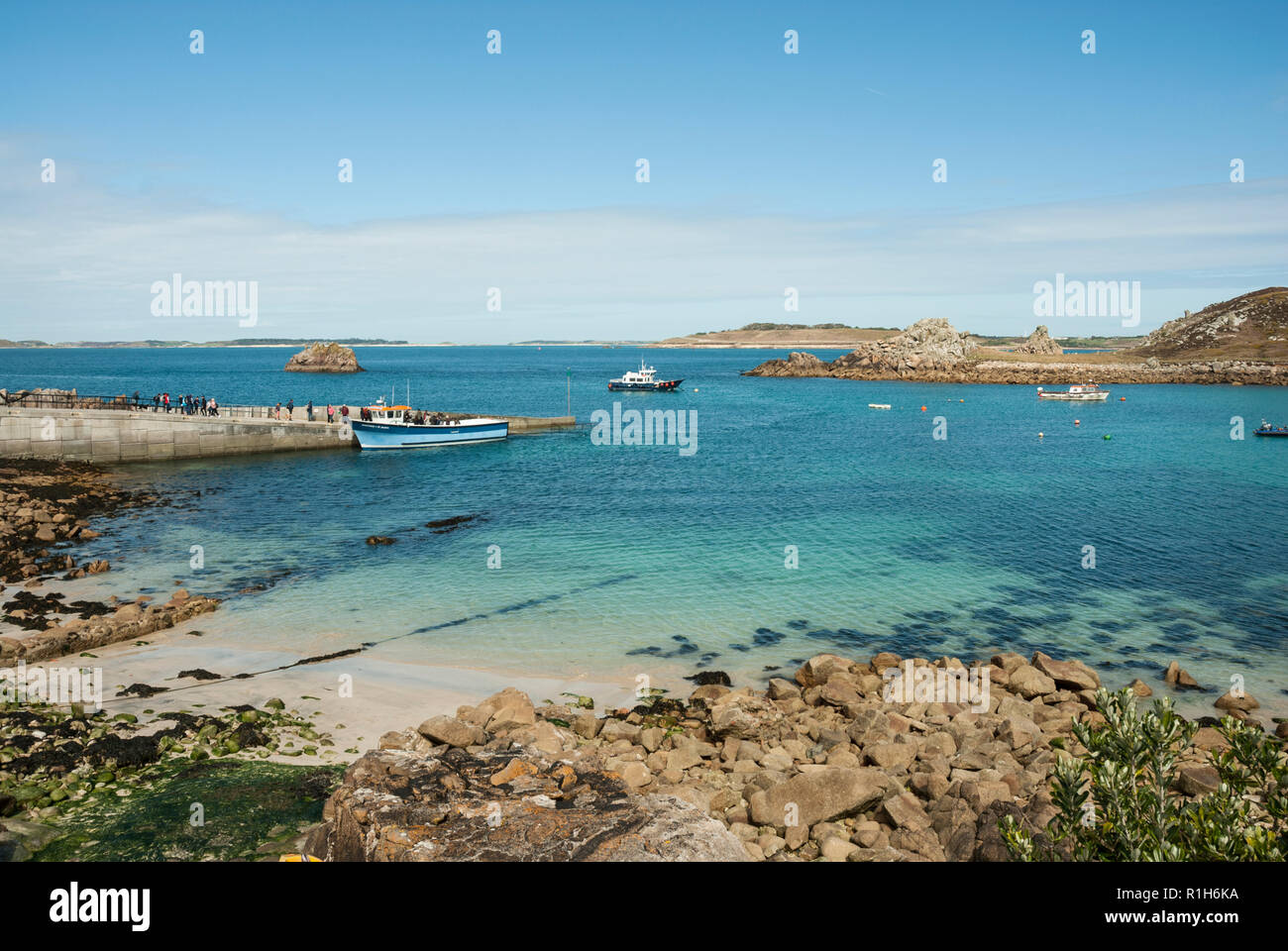 Ferries arriving at St Agnes jetty, Isles of Scilly on a clear sunny