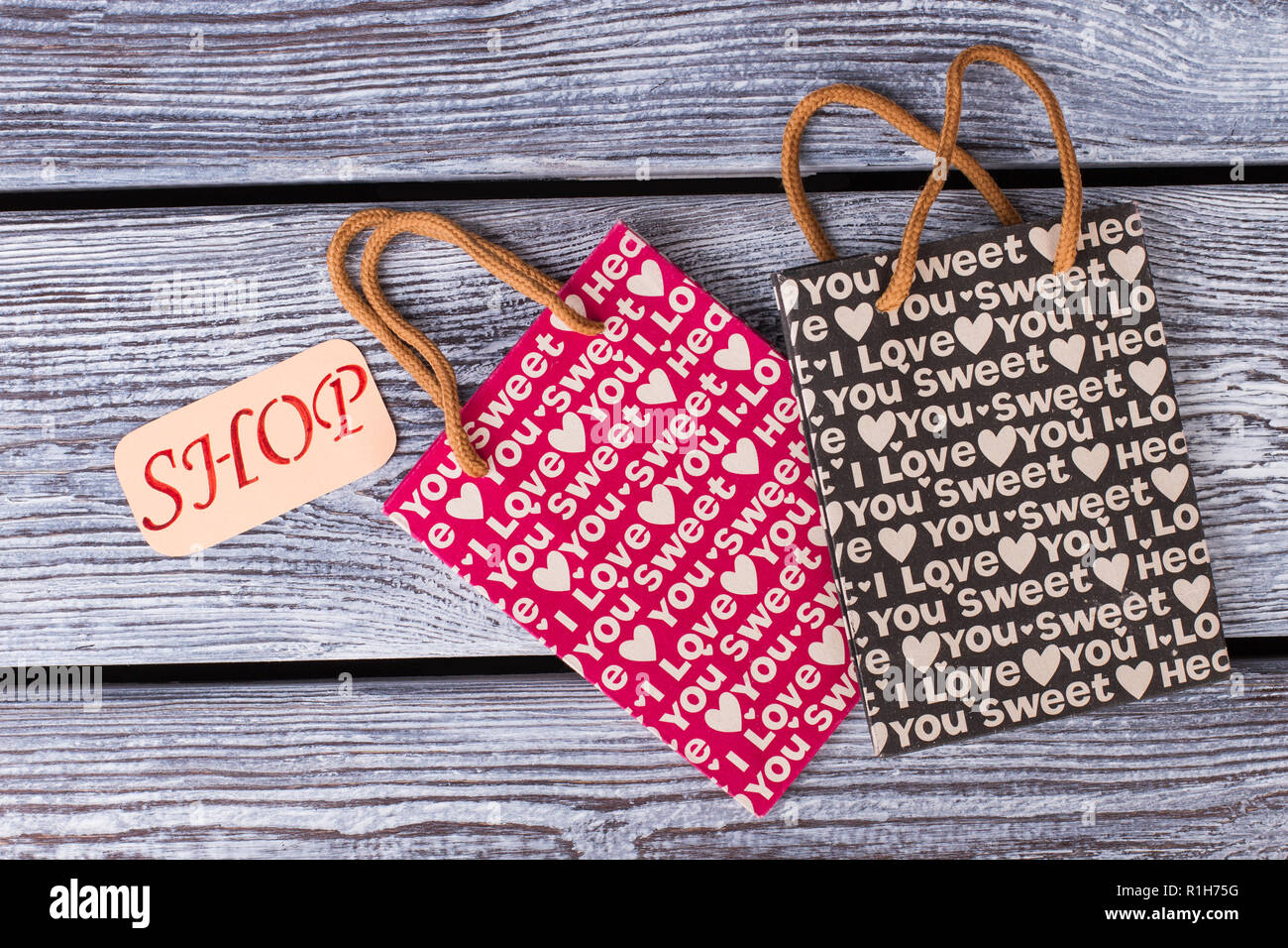 Patterned gift bags on wooden background. Stock Photo
