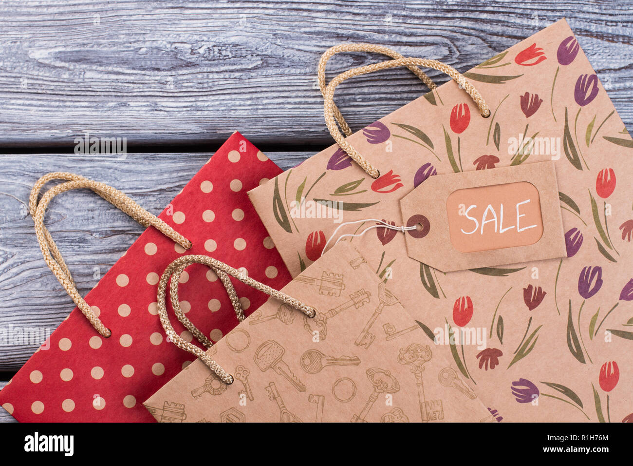 Patterned gift bags on wooden background. Stock Photo