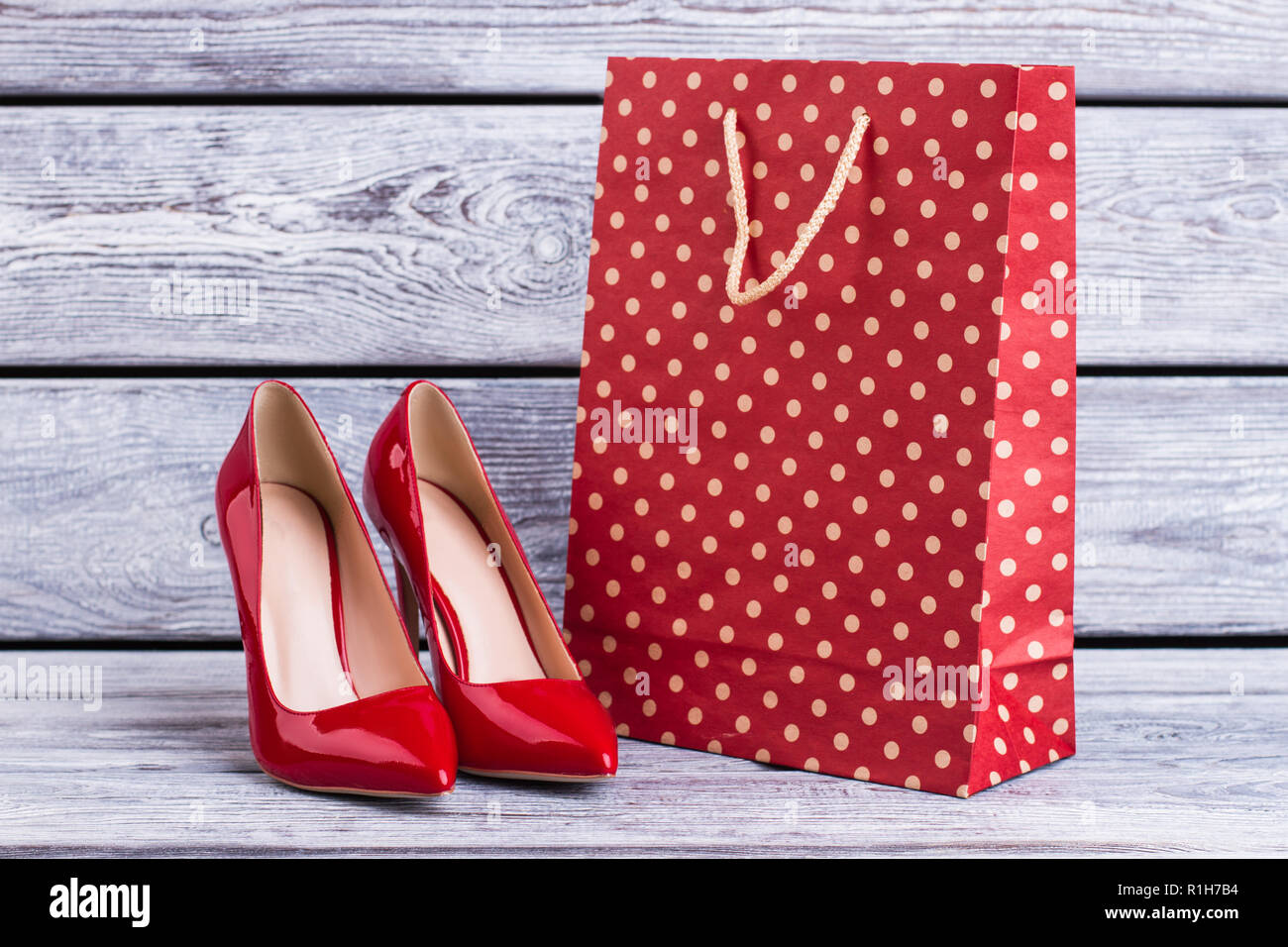 Female high heel shoes with shopping bag. Stock Photo