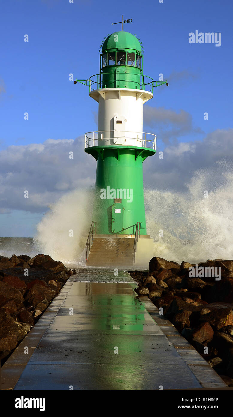 Green-white lighthouse with surf, Warnemünde, Mecklenburg-Western Pomerania, Germany Stock Photo