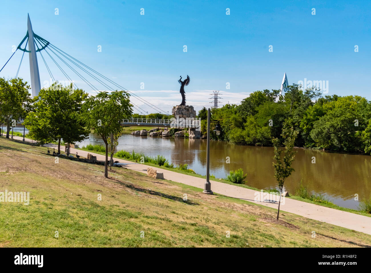 Keeper of the Plains, a steel sculpture by Blackbear Bosin. Wichita, Kansas, USA. From the south shore of the Arkansas River. Stock Photo