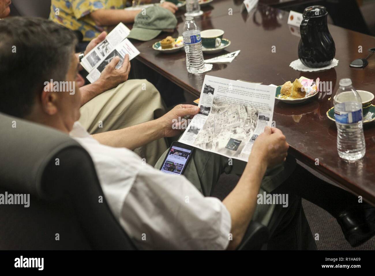 Rep. Filemon Vela (D-TX), House of Homeland Security Committee, Border and Maritime Security Subcommittee, reads a brochure about the base during a command brief at the Marine Corps Base Hawaii (MCBH) headquarters building, Sept. 19, 2018. Rep. Filemon Vela and Rep. Steve Cohen (D-TN), House of Judiciary Committee, visited MCBH to learn about the installation's support to operational readiness while maintaining awareness of cultural and environmental issues within the training areas, ranges and other aspects of the region. With this engagement, the Representative's will provide Members of Cong Stock Photo