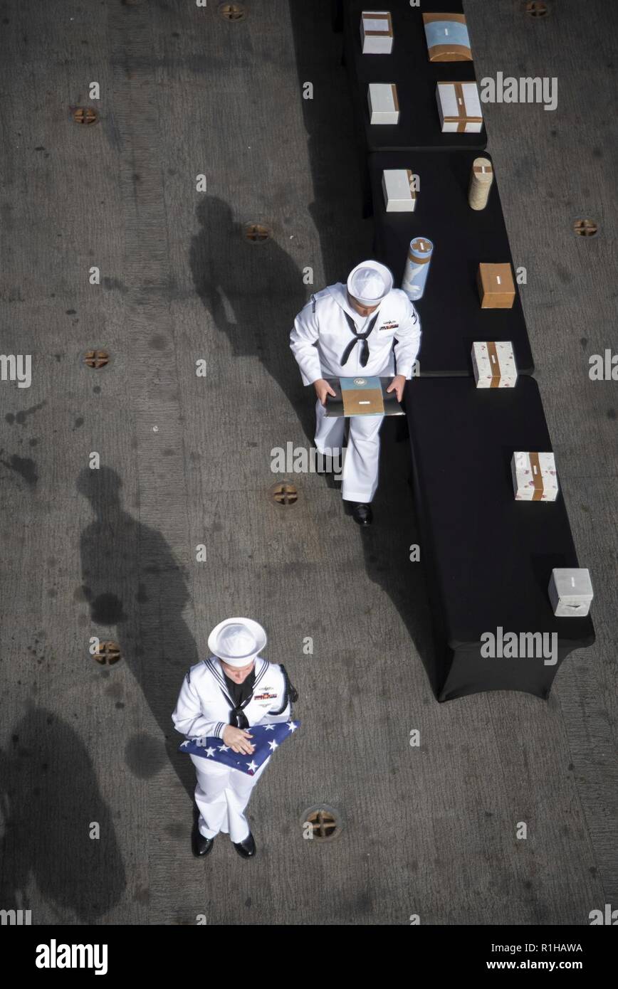 PACIFIC OCEAN (Sept. 19, 2018) Sailors, assigned to the amphibious assault ship USS Bonhomme Richard (LHD 6), participate in a burial at sea ceremony held on the ship’s starboard aircraft elevator. Bonhomme Richard is currently underway in the U.S. 3rd Fleet area of operations. Stock Photo
