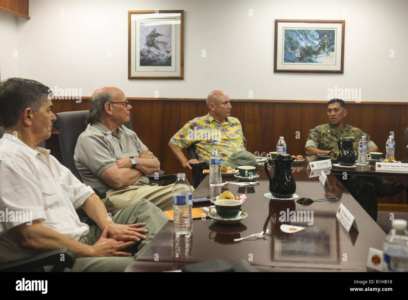 Rep. Filemon Vela (D-TX), House of Homeland Security Committee, Border and Maritime Security Subcommittee (left) and Rep. Steve Cohen (D-TN)(second from left), House of Judiciary Committee, speak with U.S. Marine Corps Col. Raul Lianez, commanding officer, Marine Corps Base Hawaii (MCBH), at the base headquarters building during their visit to MCBH, Sept. 19, 2018. Rep. Steve Cohen and Rep. Filemon Vela visited MCBH to learn about the installation's support to operational readiness while maintaining awareness of cultural and environmental issues within the training areas, ranges and other aspe Stock Photo