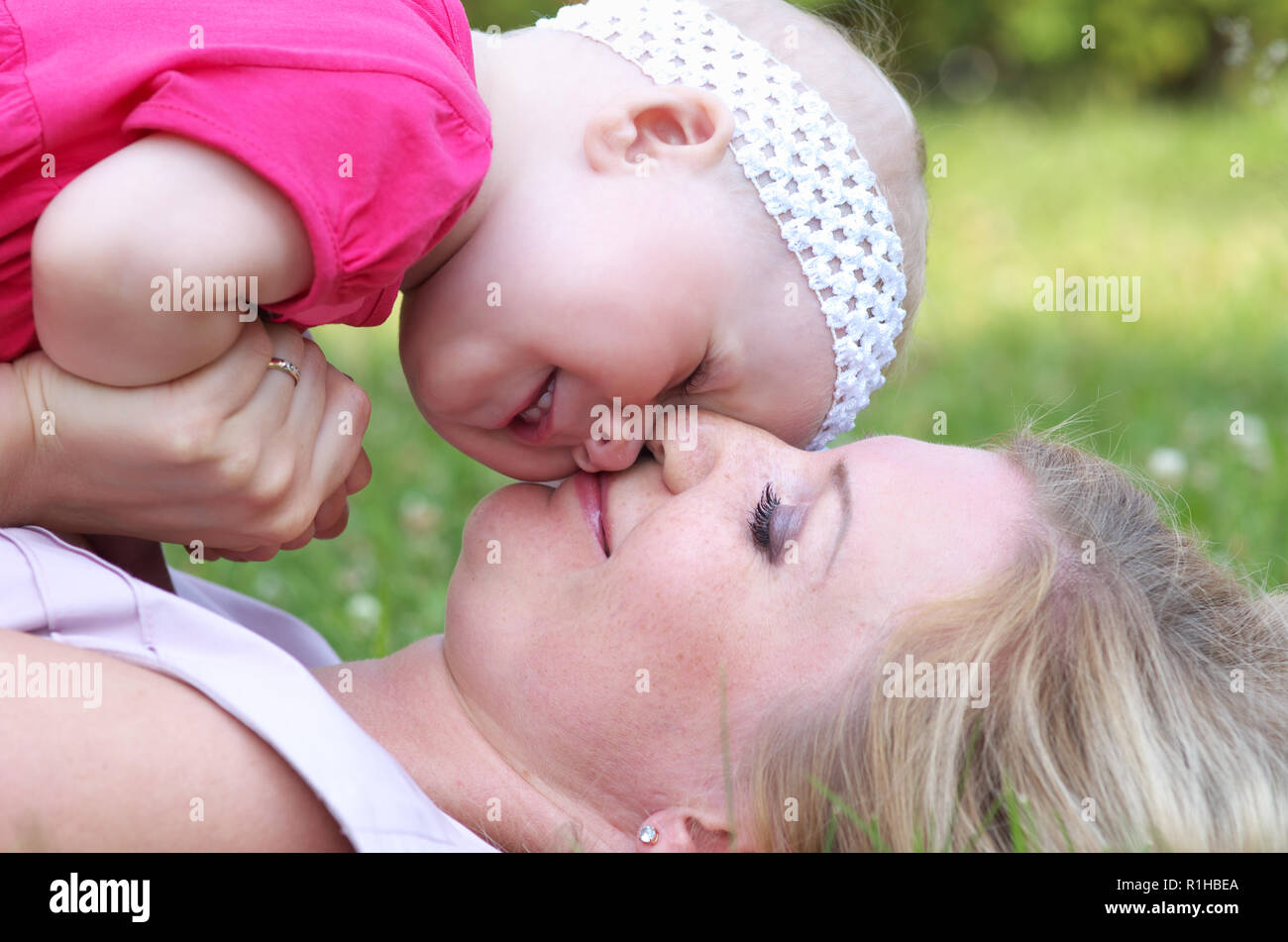 Closeup portrait of happy child with her mother Stock Photo