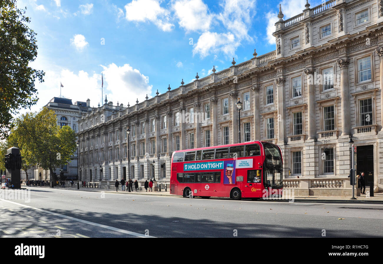 Red double-decker bus in front of the Cabinet Office, Whitehall, London, England, UK Stock Photo
