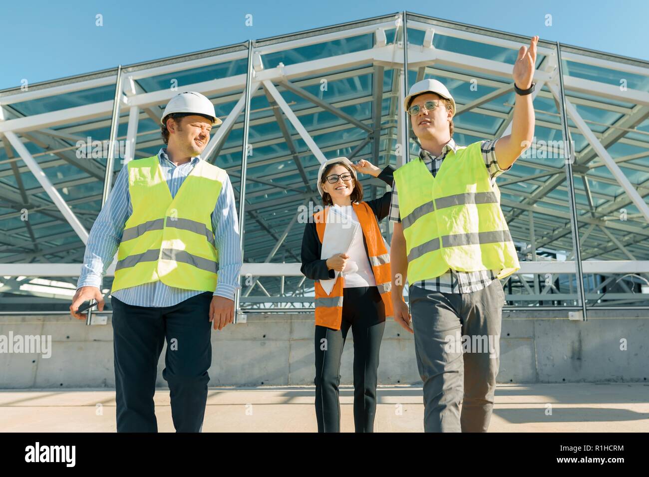 Group of engineers, builders, architects on the building site ...