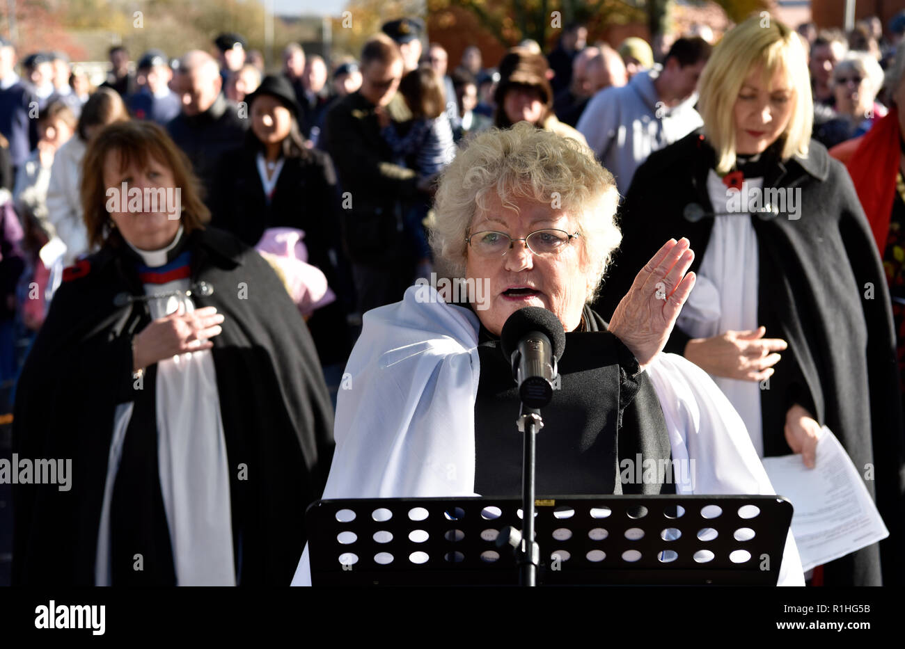 Female members of the clergy addressing audience during Remembrance Sunday, War Memorial, Bordon, Hampshire, UK. 11.11.2018. Stock Photo